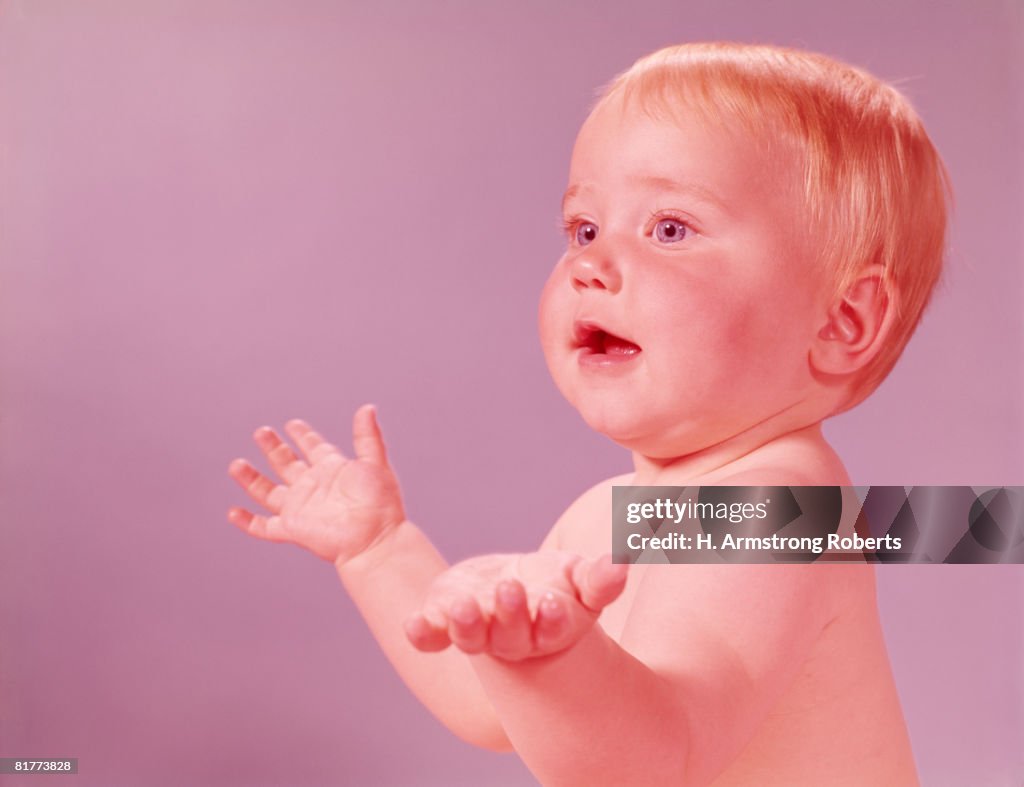 Baby holding hands up. (Photo by H. Armstrong Roberts/Retrofile/Getty Images)