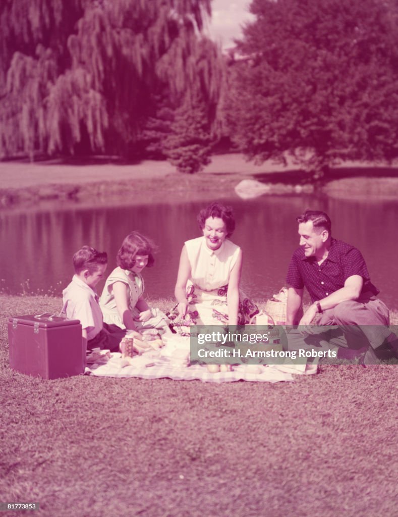 Family having picnic by lake. (Photo by H. Armstrong Roberts/Retrofile/Getty Images)