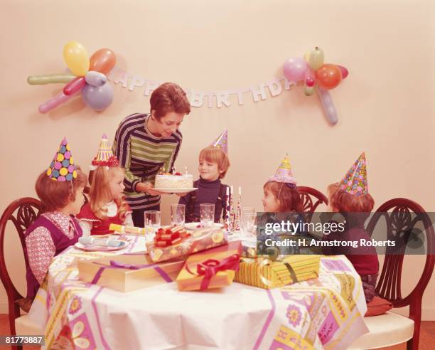 five children at birthday party, mother serving birthday cake. (photo by h. armstrong roberts/retrofile/getty images) - happy birthday vintage fotografías e imágenes de stock