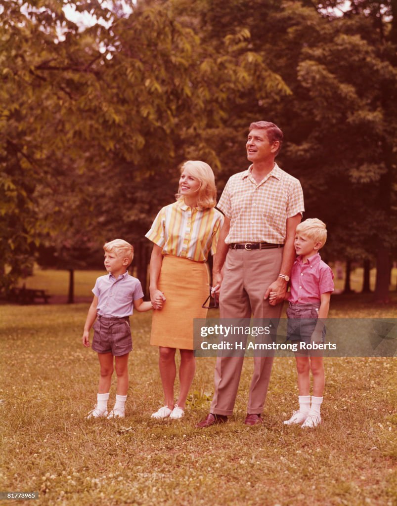 Family of four walking in park. (Photo by H. Armstrong Roberts/Retrofile/Getty Images)