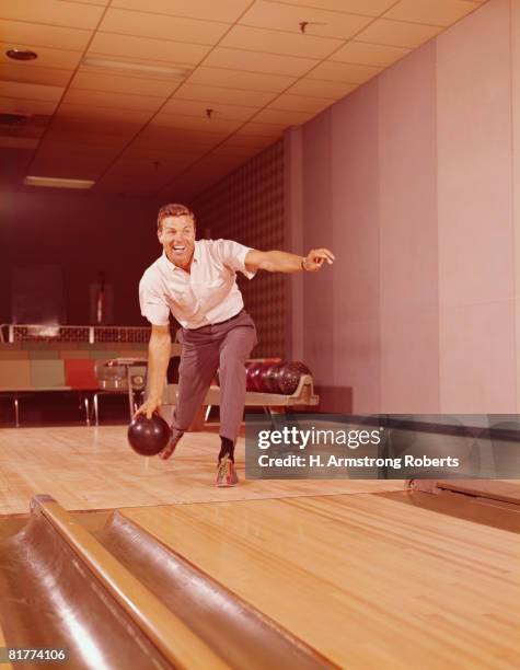 man bowling. (photo by h. armstrong roberts/retrofile/getty images) - retro bowling alley stock pictures, royalty-free photos & images