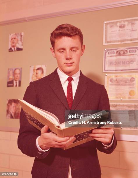 teenage student holding open book, reading aloud. - lee armstrong fotografías e imágenes de stock