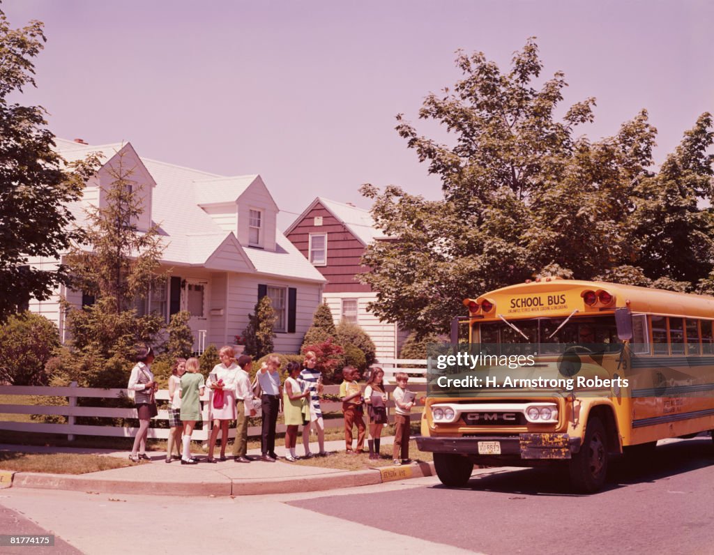 Students in line, waiting to board school bus. (Photo by H. Armstrong Roberts/Retrofile/Getty Images)