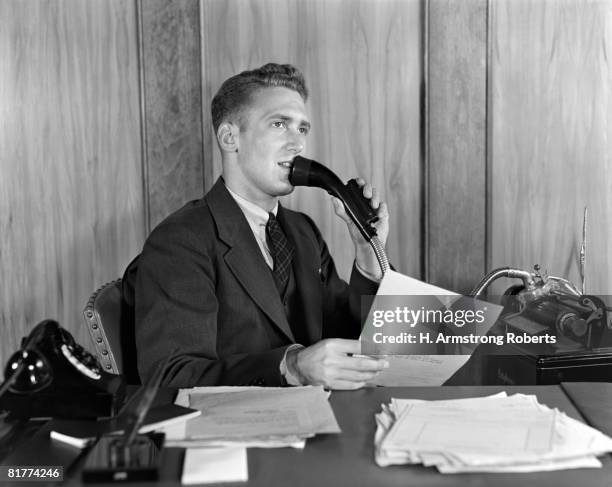 man at desk talking into dictaphone. - dictaphone stock pictures, royalty-free photos & images