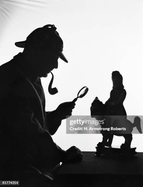 silhouette of man wearing deerstalker, dressed as sherlock holmes. (photo by h. armstrong roberts/retrofile/getty images) - deerstalker hat stock pictures, royalty-free photos & images