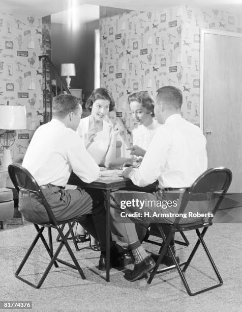 two couples playing bridge around card table. (photo by h. armstrong roberts/retrofile/getty images) - retrofile foto e immagini stock