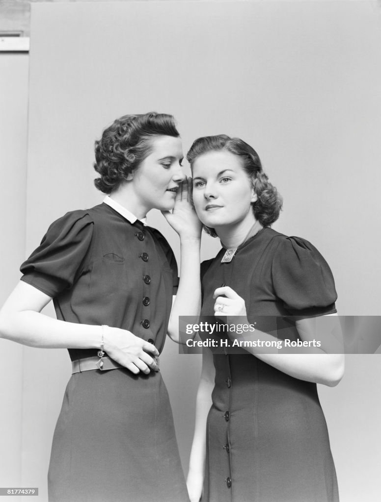 Two women whispering. (Photo by H. Armstrong Roberts/Retrofile/Getty Images)