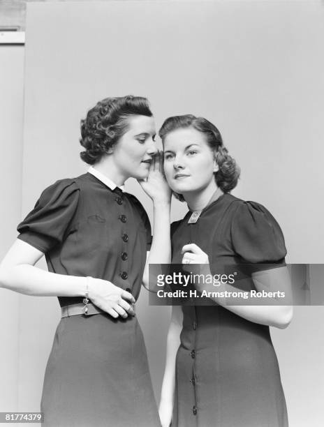 two women whispering. (photo by h. armstrong roberts/retrofile/getty images) - retrofile foto e immagini stock