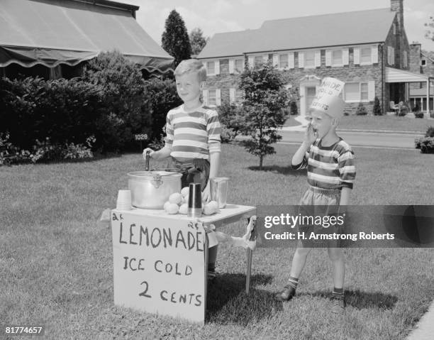 boys on lawn selling lemonade. - black and white garden stock pictures, royalty-free photos & images