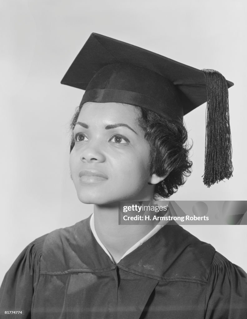 African-American woman in cap and gown, portrait.