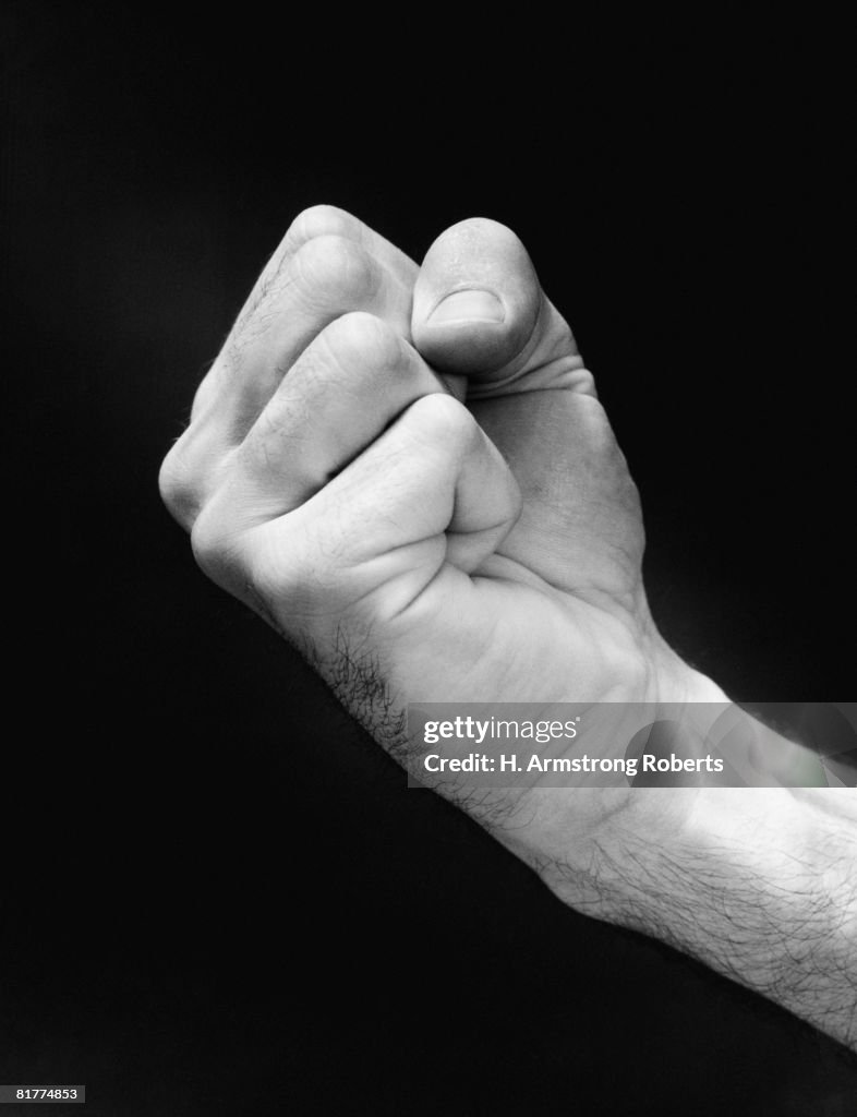 Man's hand making fist.