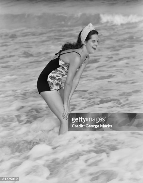 a young woman stands laughing in the surf, circa 1960. (photo by h. armstrong roberts/retrofile/getty images) - retrofile foto e immagini stock
