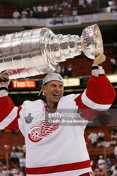 Dominik Hasek of the Detroit Red Wings celebrates with the Stanley Cup after defeating the Pittsburgh Penguins in game six of the 2008 NHL Stanley...