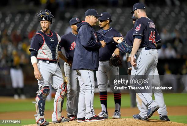 Manager Terry Francona of the Cleveland Indians makes a pitching change handing the ball over to relief pitcher Boone Logan against the Oakland...