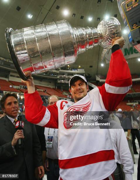 Nicklas Lidstrom of the Detroit Red Wings celebrates with the Stanley Cup after defeating the Pittsburgh Penguins in game six of the 2008 NHL Stanley...