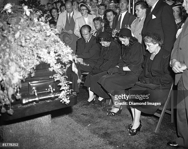 The family of Babe Ruth sits next to his casket as the last rites are given on August 19, 1948 at Gate of Heaven Cemetary in Hawthorne, New York....