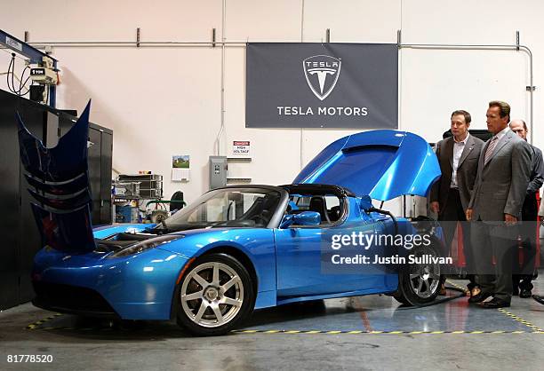 California governor Arnold Schwarzenegger and Tesla Motors Product Architect and Engineer Elon Musk look at a Tesla Roadster before a news conference...