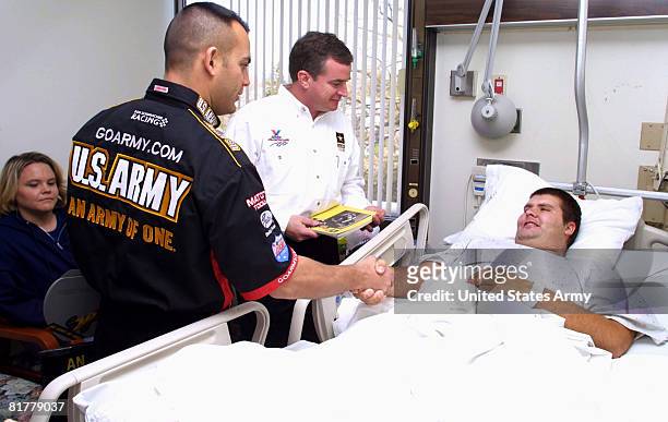 Tony "The Sarge" Schumacher , who drives the Army's dragster for the National Hot Rod Association, greets Spc. Lance Gieselmann of the 367th Armored...