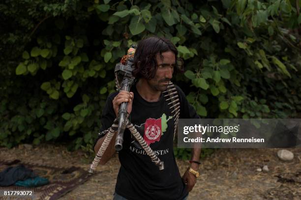 Member of the Afghan Local Police holds his weapon in the Momand Valley on July 16, 2017 in Achin District, Afghanistan. The area is where the United...