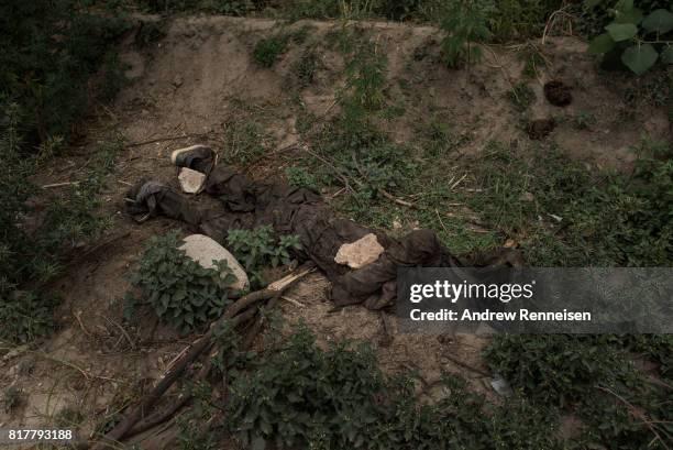 The body of an ISIS-K fighter killed by an airstrike lays on the ground a few hundred meters from where the GBU-43/B Massive Ordnance Air Blast,...