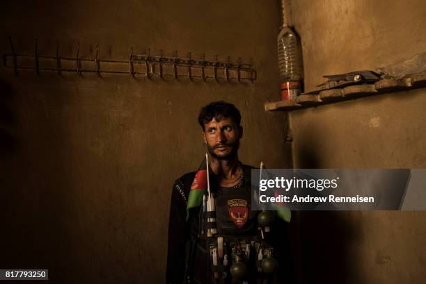 Soldier with the Afghan National Army stands in a room at an outpost in the Momand Valley on July 16, 2017 in Achin District, Afghanistan. The...