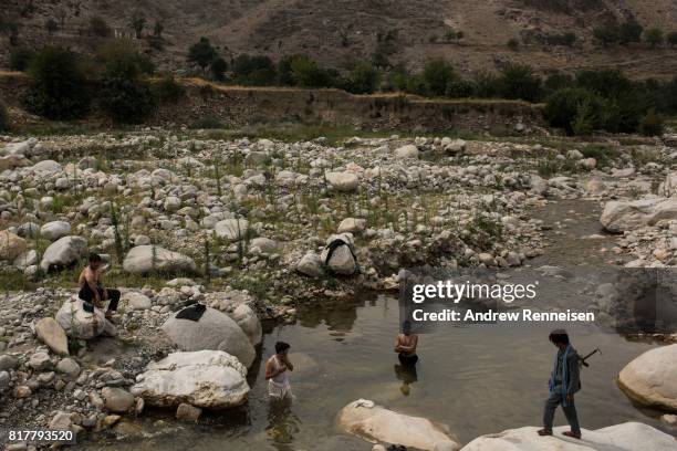 Men bathe in a river in the Momand Valley on July 16, 2017 in Achin District, Afghanistan. The area is where the United Staes dropped the GBU-43/B...