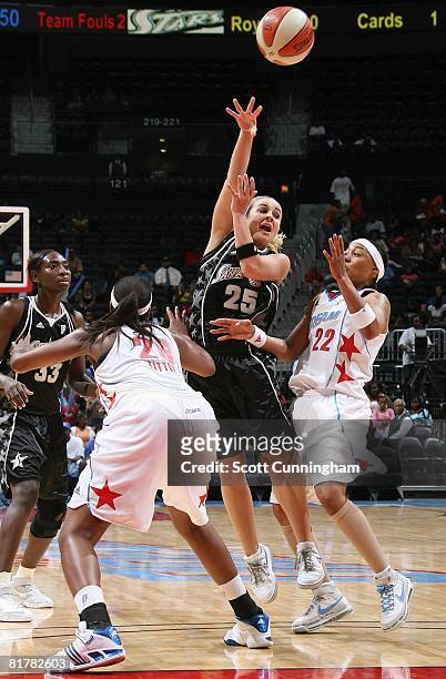 Becky Hammon of the San Antonio Silver Stars passes the ball under pressure against Betty Lennox and Camille Little of the Atlanta Dream during the...