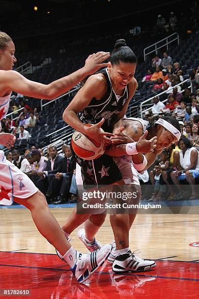 Edwige Lawson of the San Antonio Silver Stars battles for ball control against Betty Lennox and Kristen Mann of the Atlanta Dream during the WNBA...