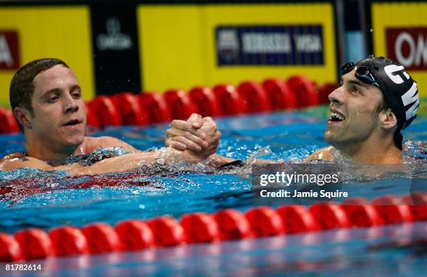 Erik Vendt and Michael Phelps celebrate after Phelps won his semifinal heat of the 200 meter freestyle during the U.S. Swimming Olympic Trials on...