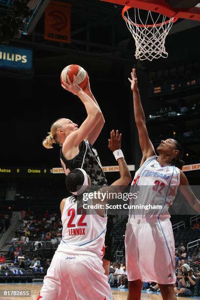 Ann Wauters of the San Antonio Silver Stars goes to the basket under pressure against Stacey Lovelace and Ivory Latta of the Atlanta Dream during the...