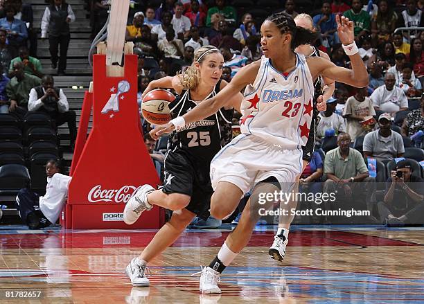 Becky Hammon of the San Antonio Silver Stars drives down the court against Tamera Young of the Atlanta Dream during the WNBA game on June 18, 2008 at...