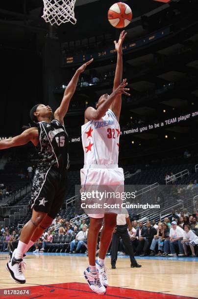 Stacey Lovelace of the Atlanta Dream shoots a layup under pressure against Vickie Johnson of the San Antonio Silver Stars during the WNBA game on...