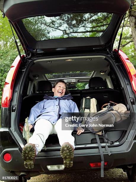 women laughs and falls back into auto after hiking - king's lynn stock pictures, royalty-free photos & images