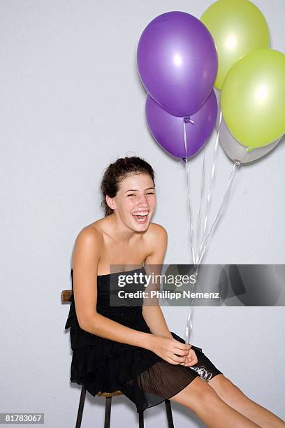 girl in black dress holding balloons, laughing. - philipp nemenz bildbanksfoton och bilder