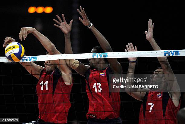 Ernardo Gomez , Ivan Marquez and Luis Diaz of Venezuela try to block a ball during their International Volleyball Federation World League volleyball...