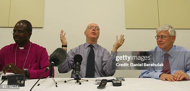 Archbishop Greg Venables gestures as he fields questions from media as Archbishops Henry Orombi from Uganda and Peter Jensen from Australia look on...