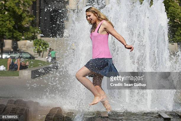 Young woman cools off at a water fountain as temperatures reached 27 degrees Celsius on July 1, 2008 in Berlin, Germany. The weather forecast for...