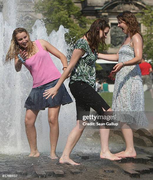 Young women cool off at a water fountain as temperatures reached 27 degrees Celsius on July 1, 2008 in Berlin, Germany. The weather forecast for...