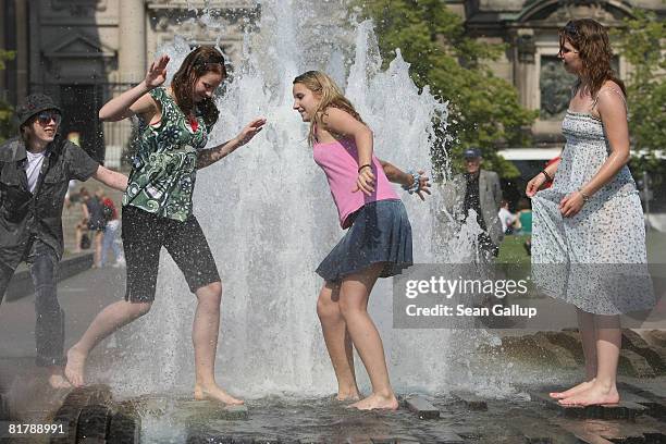 Young women cool off at a water fountain as temperatures reached 27 degrees Celsius on July 1, 2008 in Berlin, Germany. The weather forecast for...