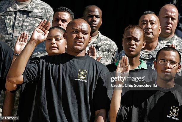 Eric Myers of Woodbridge, Virginia, joins 15 other new recruits, or "future soldiers," in taking the oath to join the U.S. Army at the Pentagon July...