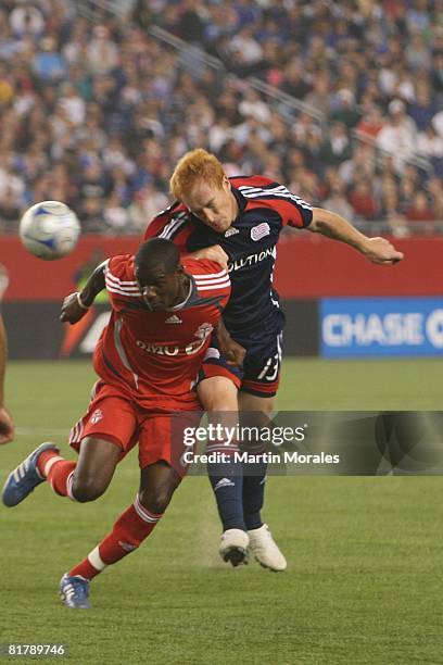 Jeff Larentowicz of the New England Revolution and Maurice Edu of the Toronto FC battle for a header at Gillette Stadium on June 28, 2008 in...