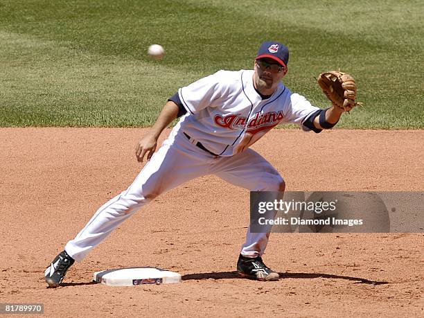 Second baseman Jamey Carroll of the Cleveland Indians catches a throw from the catcher in between innings of a game with the Chicago White Sox on...