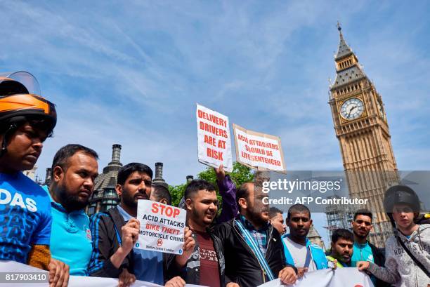 Motorcycle delivery drivers and motorcyclists take part in a demonstration in Parliament Square in central London on July 18 following a spate of...