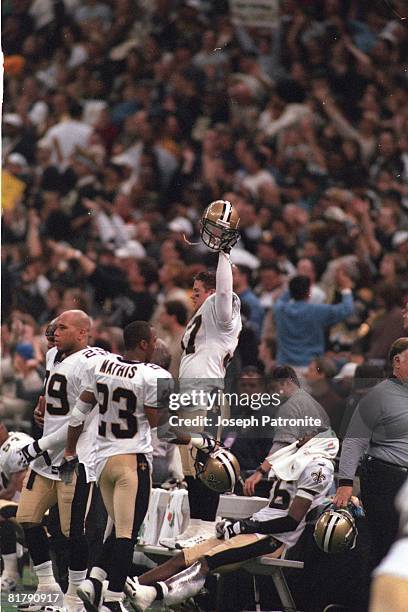 Safety Steve Gleason of the New Orleans Saints celebrates on the bench against the St. Louis Rams in the 2000 NFC Wild Card Game at the Superdome on...