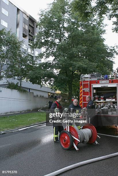 Firemen are seen at the burnt down tower block on July 1, 2008 in Erkrath near Duesseldorf, Germany. Three persons injured, one heavily, said a...