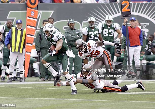 New York Jets Wide Receiver Laveranues Coles breaking away from Tampa Bays Cornerback Ronde Barber and Cornerback Brian Kelly during the Tampa Bay...