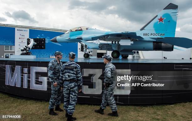 Russian soldiers stand next to the new Russian fighter jet MIG 35 on July 18, 2017 during the annual air show MAKS 2017 in Zhukovsky, some 40 km...