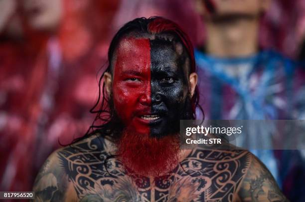 An AC Milan supporter watches from the stands as the team plays Barussia Dortmund during their International Champions Cup football match in...