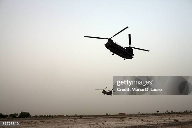 Two Royal air Force Chinook Helicopter fly over British Paratroopers from the 3rd Battalion The Parachute Regiment during an operation to search...