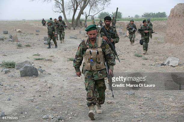 Members of the Afghan Security Forces take part in an operation to search three compounds and look for weapons on July 1, 2008 in Salavat, Panjawi...